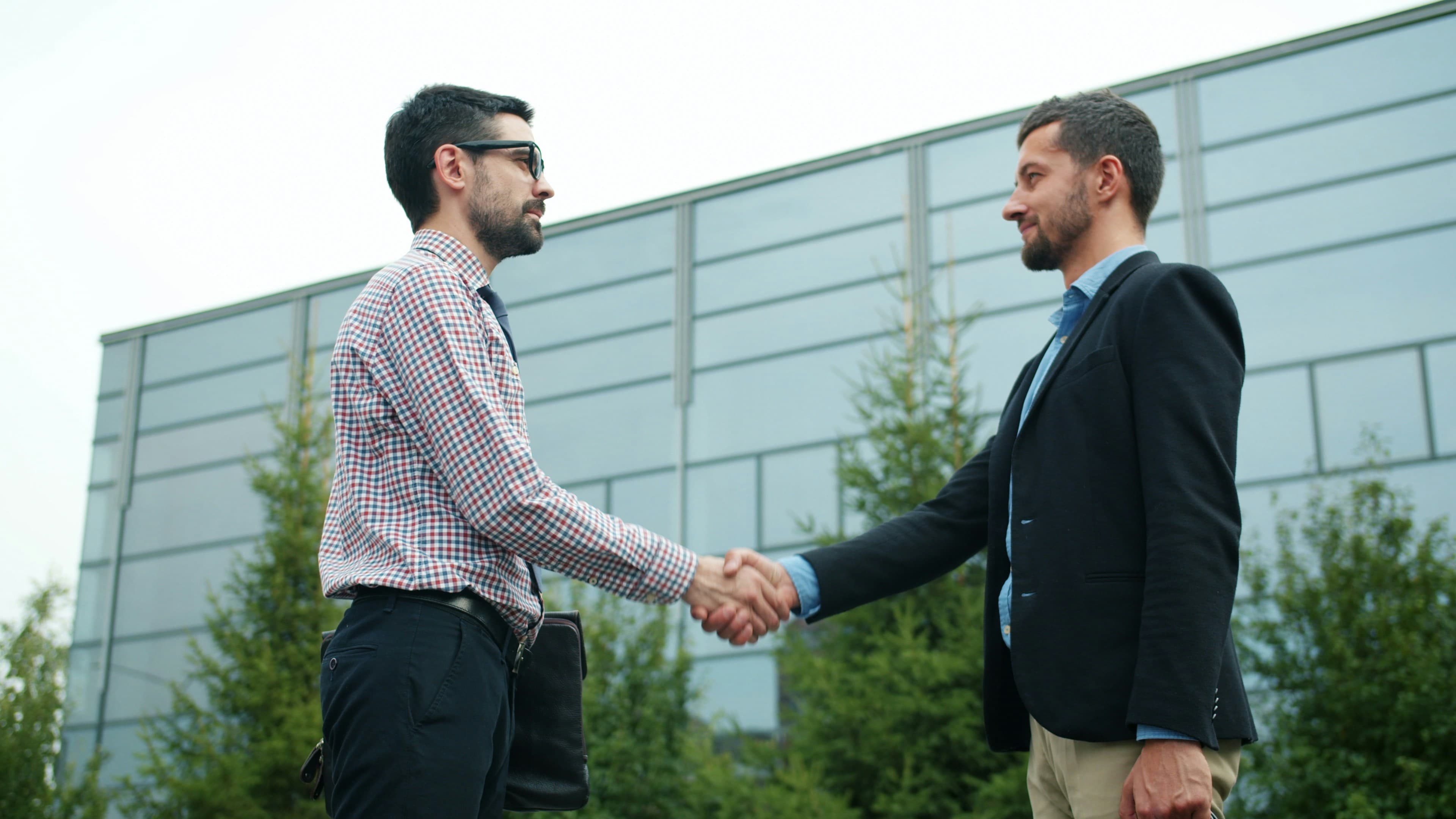 Two men shake hands