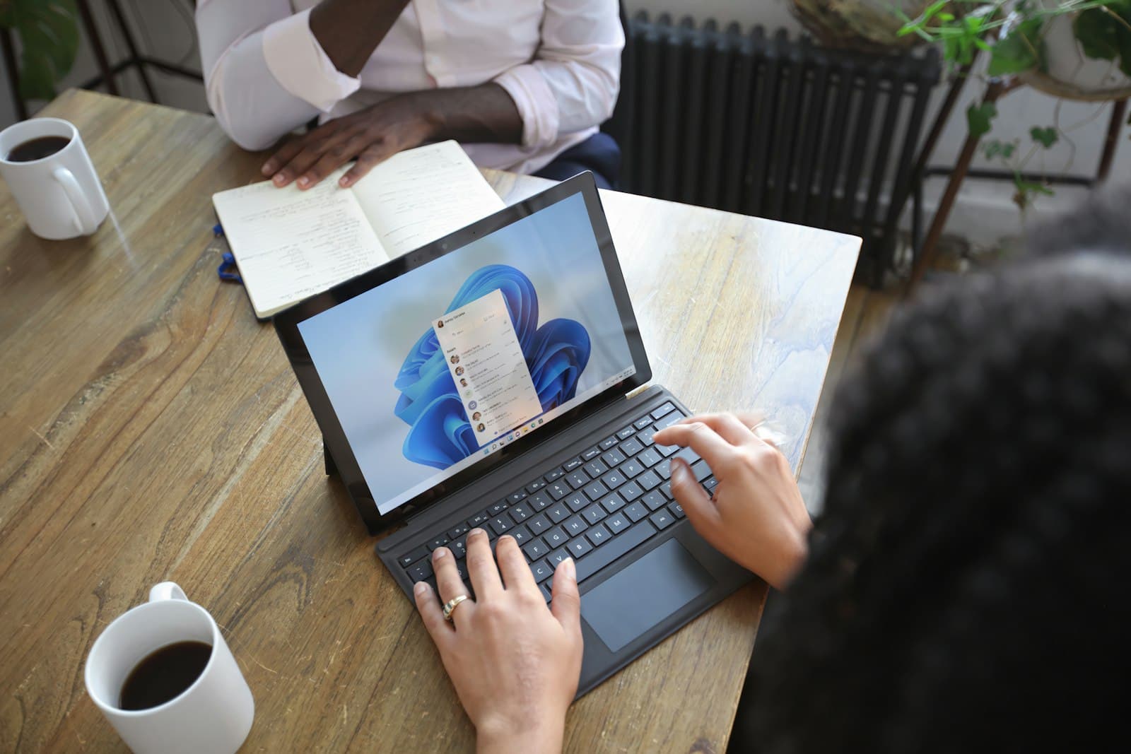 Advisors in conversation across a meeting table